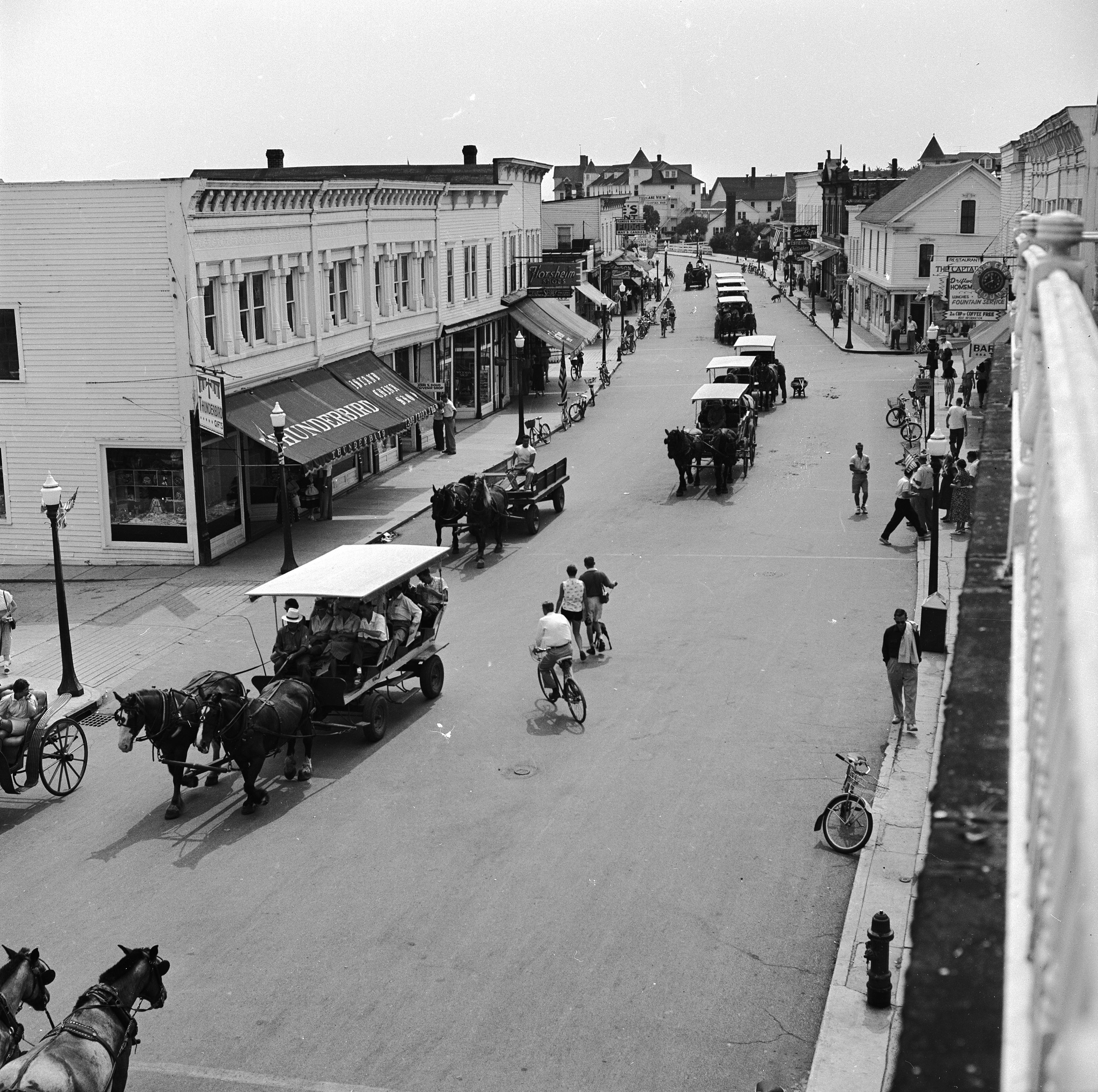 circa 1955: Horse drawn carts and bicyles passing along the main street of Mackinac Island, Michigan where the use of cars is prohibited. (Photo by Orlando /Three Lions/Getty Images)